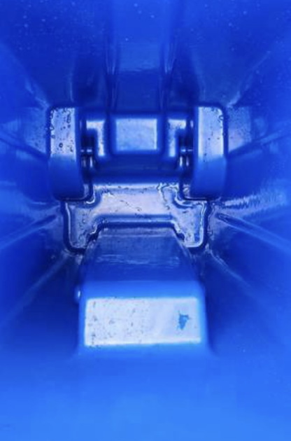 Close-up of the washed interior of a blue bin after cleaning